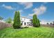 A backyard with a wooden deck, well-manicured lawn, mature trees, and a privacy fence at 14030 Avalon East Dr, Fishers, IN 46037