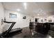 Bright basement area with a treadmill, complemented by a bar area for entertainment and relaxation at 14030 Avalon East Dr, Fishers, IN 46037
