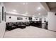 Large basement area features an oversized leather sofa, a bar, and modern lighting at 14030 Avalon East Dr, Fishers, IN 46037