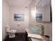 Bright half-bathroom with a glass vessel sink, modern fixtures, and a decorative mirror adding a touch of elegance at 14030 Avalon East Dr, Fishers, IN 46037