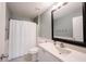 Bathroom featuring walk-in shower with white shower curtain, toilet and large mirror over vanity at 14030 Avalon East Dr, Fishers, IN 46037