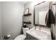Charming powder room with gray vanity, marble countertop, and decorative wooden shelves at 14030 Avalon East Dr, Fishers, IN 46037