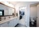 Bright bathroom with double sinks, large mirror and view of walk-in closet at 14030 Avalon East Dr, Fishers, IN 46037