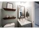 Cozy bathroom featuring a wooden-framed mirror, stylish gray vanity, and decorative accents at 14030 Avalon East Dr, Fishers, IN 46037