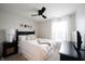 Neutral bedroom features a modern ceiling fan, cozy bed, and black nightstand at 14030 Avalon East Dr, Fishers, IN 46037