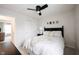 Neutral bedroom with a modern ceiling fan, cozy bed, and ensuite bathroom at 14030 Avalon East Dr, Fishers, IN 46037