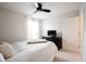 Neutral bedroom with a modern ceiling fan, cozy bed and mounted television at 14030 Avalon East Dr, Fishers, IN 46037