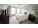 Bright bedroom featuring a comfortable bed, white linens, and abundant natural light from large windows at 14030 Avalon East Dr, Fishers, IN 46037