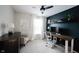 Bedroom featuring a modern ceiling fan, dark accent wall, and floating shelves at 14030 Avalon East Dr, Fishers, IN 46037