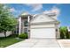 Charming two-story brick home featuring an attached garage, manicured lawn, and a welcoming front entrance at 14030 Avalon East Dr, Fishers, IN 46037