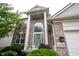 Detailed view of the home's entrance, showcasing the brick facade, columns, and arched window at 14030 Avalon East Dr, Fishers, IN 46037