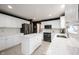 Well-lit kitchen with white cabinets, stainless steel appliances, a central island, and elegant countertops at 14030 Avalon East Dr, Fishers, IN 46037