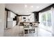 Modern kitchen with white cabinets, stainless steel appliances, and a stylish dining area at 14030 Avalon East Dr, Fishers, IN 46037