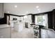 Modern white kitchen featuring stainless steel appliances, a center island, and a cozy dining area at 14030 Avalon East Dr, Fishers, IN 46037