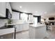 Open concept kitchen with white cabinets, island, stainless steel appliances, and bright natural light at 14030 Avalon East Dr, Fishers, IN 46037