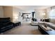 Spacious living room with a comfortable sofa and open view to the kitchen and dining area at 14030 Avalon East Dr, Fishers, IN 46037