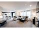 Bright and spacious living room open to the kitchen, featuring a comfortable sofa and fireplace at 14030 Avalon East Dr, Fishers, IN 46037