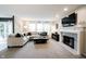 Open-concept living room with a fireplace, large windows, and comfortable seating at 14030 Avalon East Dr, Fishers, IN 46037