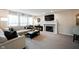 Inviting living room with a fireplace, plush sofa, and large windows for natural light at 14030 Avalon East Dr, Fishers, IN 46037