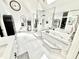 A luxurious primary bathroom with a glass enclosed shower, soaking tub and marble flooring at 14035 Stone Key Way, Fishers, IN 46037