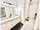 Bright bathroom features a double sink vanity with granite countertops, tiled floors, and a shower with a curtain at 14035 Stone Key Way, Fishers, IN 46037