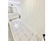 This bright, tiled bathroom features a single sink vanity, mirror, toilet, and bath with white walls and new fixtures at 14035 Stone Key Way, Fishers, IN 46037