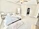 Bright, carpeted bedroom with ceiling fan, side tables, walk-in closet, and large window that provides ample natural light at 14035 Stone Key Way, Fishers, IN 46037