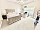 Bedroom offers a queen-size bed, desk, and nightstand with a window overlooking the backyard that provides natural light at 14035 Stone Key Way, Fishers, IN 46037