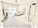 Bright, carpeted bedroom with ceiling fan, side tables, walk-in closet, and large window that provides ample natural light at 14035 Stone Key Way, Fishers, IN 46037