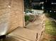 A winding wooden walkway with landscape lighting leads to a covered boat dock with waterfront access at 14035 Stone Key Way, Fishers, IN 46037