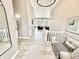 Bright foyer features wood floors, a large mirror, and a view into the open-concept living spaces at 14035 Stone Key Way, Fishers, IN 46037