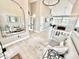 Bright foyer with wood floors, a large mirror, and an open view to the living spaces with high ceilings at 14035 Stone Key Way, Fishers, IN 46037