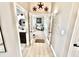 Hallway view to the powder room and the office featuring wood floors and updated decor at 14035 Stone Key Way, Fishers, IN 46037