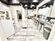 Kitchen with modern appliances and wood-look vinyl flooring, featuring an island that opens to the basement living space at 14035 Stone Key Way, Fishers, IN 46037