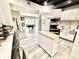 Kitchen with modern appliances opens to the basement living space and features vinyl flooring and stainless steel appliances at 14035 Stone Key Way, Fishers, IN 46037