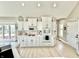 Charming kitchen featuring white cabinets, stainless steel appliances, and quartz countertops, offering a modern feel at 14035 Stone Key Way, Fishers, IN 46037