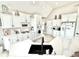 Modern kitchen featuring white cabinets, stainless steel appliances, quartz countertops, and a black undermount sink at 14035 Stone Key Way, Fishers, IN 46037