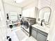 Laundry room with gray cabinets, stainless steel washer and dryer, and stylish tile flooring at 14035 Stone Key Way, Fishers, IN 46037