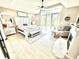 Bright main bedroom featuring high ceilings, a king-size bed, a fireplace, and access to outdoor views at 14035 Stone Key Way, Fishers, IN 46037