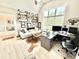 Bright office space with a large window, built-in shelving and a comfortable seating area for relaxing at 14035 Stone Key Way, Fishers, IN 46037