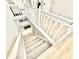 View of a white staircase with carpeted steps and wood floors at 14035 Stone Key Way, Fishers, IN 46037