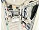 An organized walk-in closet showcasing ample storage with custom shelving and rods at 14035 Stone Key Way, Fishers, IN 46037