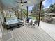 Inviting back patio with a hot tub, ceiling fan, patio lights, and nearby access to the canal at 14035 Stone Key Way, Fishers, IN 46040