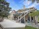 Spacious backyard deck with stairs to the second level, hot tub, and American flag in background at 14035 Stone Key Way, Fishers, IN 46040