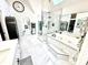 Luxurious bathroom featuring a soaking tub, separate shower, and marble tiling throughout the room at 14035 Stone Key Way, Fishers, IN 46040