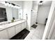 Bathroom with a dual sink vanity, a shower, and modern light fixtures at 14035 Stone Key Way, Fishers, IN 46040