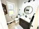 Stylish half bathroom featuring modern fixtures, herringbone tile accent wall, and natural light at 14035 Stone Key Way, Fishers, IN 46040