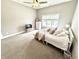 Light-filled bedroom with a large window, neutral walls, and soft carpet at 14035 Stone Key Way, Fishers, IN 46040