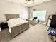 Cozy bedroom with neutral carpet, a ceiling fan, and a built in desk area at 14035 Stone Key Way, Fishers, IN 46040