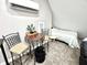 Bright bedroom featuring a cozy dining area with seating and carpet flooring, complete with modern AC unit at 14035 Stone Key Way, Fishers, IN 46040